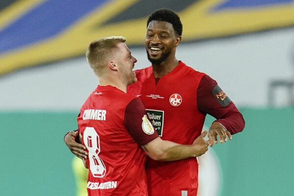 Kaiserslautern's Almamy Toure, right, celebrates with Jean Zimmer after scoring their side's second goal during the German Soccer Cup semifinal soccer match between 1. FC Saarbrucken and 1. FC Kaiserslautern at Ludwigspark Stadium in Saarbrucken, Germany, Tuesday, April 2, 2024. (Uwe Anspach/dpa via AP)