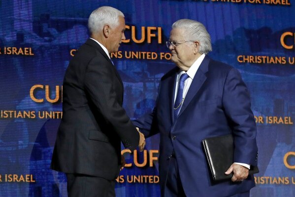 FILE - In this July 8, 2019 file photo, Vice President Mike Pence, left, greets Pastor John Hagee, founder and chairman of Christians United for Israel in Washington. Prominent Texas megachurch pastor and conservative activist John Hagee has been diagnosed with COVID-19. Hagee's son, Matt Hagee, announced the illness during Sunday, OCT. 4, 2020, morning services at Cornerstone Church, which his father founded. (AP Photo/Patrick Semansky File)