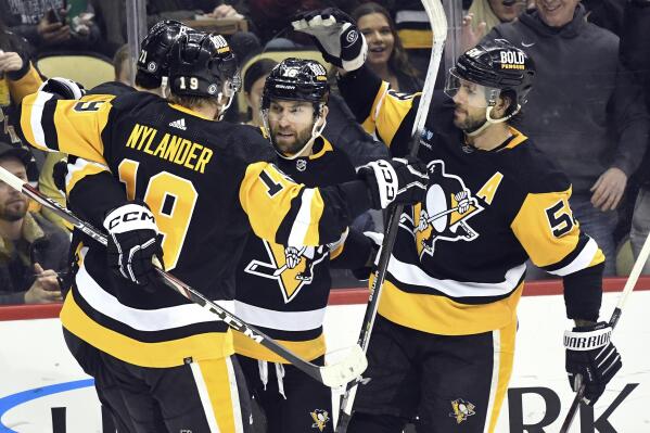 Pittsburgh Penguins left wing Jason Zucker (16) celebrates a goal with center Evgeni Malkin (71), forward Alex Nylander (19), and defenseman Kris Letang (58) while playing the Columbus Blue Jackets during the second period of an NHL hockey game, Tuesday, March 7, 2023, in Pittsburgh. (AP Photo/Philip G. Pavely)