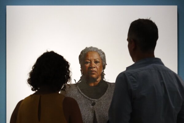 Visitors view a portrait of Nobel laureate Toni Morrison, painted by the artist Robert McCurdy, Tuesday, Aug. 6, 2019, at the National Portrait Gallery in Washington. Morrison, a pioneer and reigni...