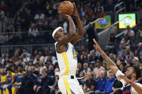 Golden State Warriors forward Jimmy Butler III, left, shoots over Los Angeles Clippers guard Norman Powell during the first half of an NBA basketball game Sunday, April 13, 2025, in San Francisco. (AP Photo/Godofredo A. Vásquez)