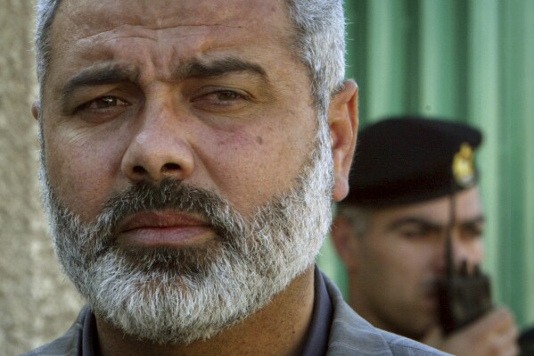 FILE - Palestinian Hamas leader Ismail Haniyeh speaks to the media after his meeting with Egyptian officials at the Egyptian diplomatic mission in Gaza City, Feb. 10, 2006. Hamas has refused to release more hostages until Israel ends its offensive and withdraws from Gaza. It wants a broader agreement that would include a long-term truce and reconstruction. The group's top political leader said Tuesday, Jan. 30, 2024, its priority is the 