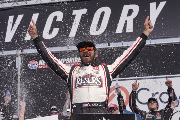 Martin Truex Jr., celebrates his win in the Crayon 301 NASCAR Cup Series auto race, Monday, July 17, 2023, at New Hampshire Motor Speedway, in Loudon, N.H. (AP Photo/Steven Senne)