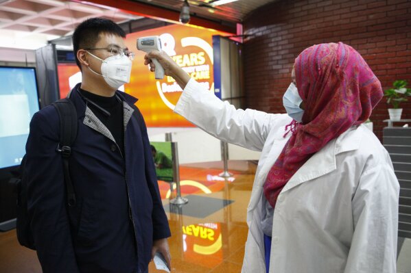 A passenger from Beijing is screened as part of measures to prevent coronavirus infection at Hazrat Shahjalal International airport in Dhaka, Bangladesh, Wednesday, Jan.29, 2020. (AP Photo/Al-emrun Garjon)