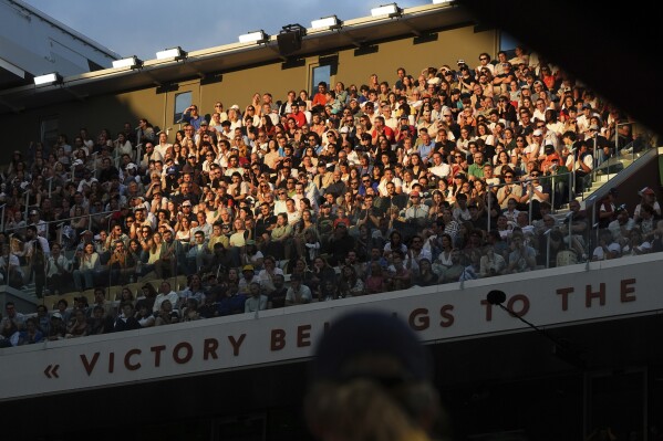 The evening sun hits the stands during a second-round match between Britain's Jack Draper and France's Gael Monfils in the French Tennis Open at the Roland-Garros stadium in Paris, Thursday, May 29, 2025. (AP Photo/Lindsey Wasson)