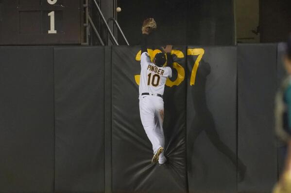 Oakland Athletics right fielder Chad Pinder (10) cannot catch a home run hit by Seattle Mariners' Luis Torrens during the eighth inning of a baseball game in Oakland, Calif., Wednesday, Sept. 21, 2022. (AP Photo/Jeff Chiu)