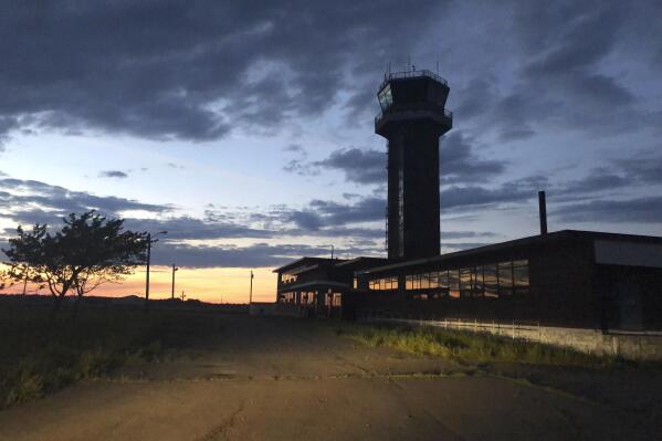 FILE — The sun sets behind the control tower of the former Loring Air Force Base, Saturday, July 18, 2020, in Limestone, Maine. The Air Force plans to test multiple sites at the former Loring Air Force Base for contamination by so-called forever chemicals. Officials are concerned that PFAS contamination from firefighting foam used on Loring's runway may have spread elsewhere. So far, it has not been found in any drinking water supplies. (AP Photo/David Sharp, File)