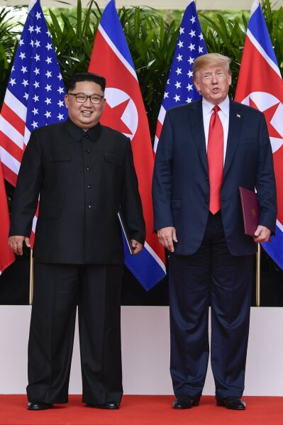 
              North Korea leader Kim Jong Un and U.S. President Donald Trump stand side by side before their departures after meeting at the Capella resort on Sentosa Island Tuesday, June 12, 2018 in Singapore. (AP Photo/Susan Walsh, Pool)
            