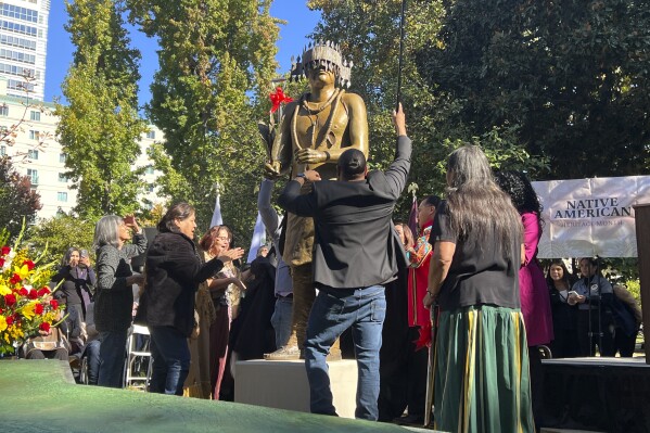 A Native American monument is unveiled in Sacramento, Calif., Tuesday, Nov. 7, 2023. California lawmakers and Native American tribes celebrated the unveiling of a monument outside of the state Capitol building to commemorate the history of Sacramento-area tribes. The monument reveal comes years after protesters tore down a statue of a Spanish missionary in the state's historic Capitol Park. (AP Photo/Sophie Austin)