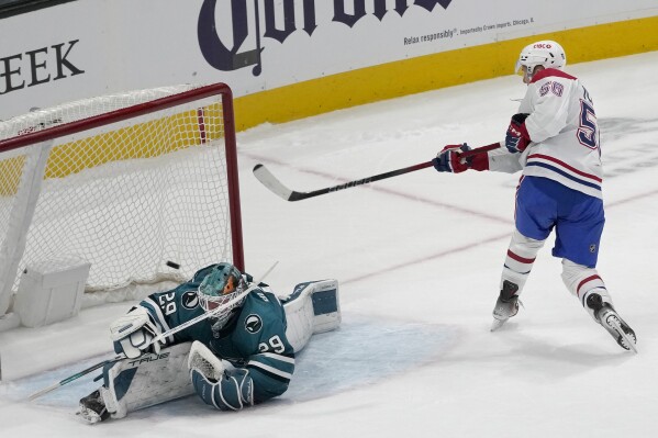 Montreal Canadiens right wing Jesse Ylönen (56) scores past San Jose Sharks goaltender Mackenzie Blackwood (29) during the shootout in an NHL hockey game in San Jose, Calif., Friday, Nov. 24, 2023. The Canadiens won 3-2. (AP Photo/Jeff Chiu)