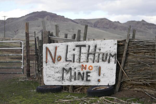 A "No Lithium No Mine" sign is displayed on April 24, 2023, on the Fort McDermitt Indian Reservation, near McDermitt, Nev. The Biden administration says it has completed a court-ordered review that should ensure construction continues at the Nevada lithium mine, despite legal challenges brought by conservationists and tribal leaders. (AP Photo/ Rick Bowmer)