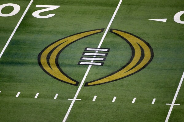 FILE - The College Football Playoff logo is shown on the field at AT&T Stadium before the Rose Bowl NCAA college football game between Notre Dame and Alabama in Arlington, Texas, Jan. 1, 2021. The field for the 12-team College Football Playoff will comprise five conference champions and seven at-large selections after the university presidents who oversee the CFP voted unanimously Tuesday, Feb. 20, 2024, to tweak the format. (APPhoto/Roger Steinman, File)