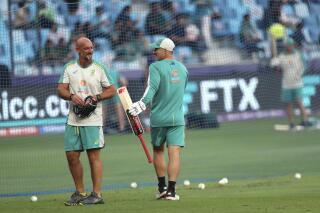 Australia's Josh Inglis, right, talks to a members of his team support staff before their match against Pakistan during the Cricket Twenty20 World Cup second semi-final in Dubai, UAE, Thursday, Nov. 11, 2021. (AP Photo/Aijaz Rahi)