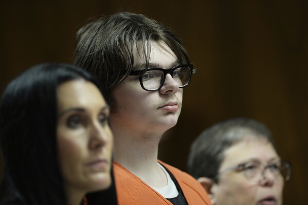 FILE - Ethan Crumbley stands with his attorneys, Paulette Loftin and Amy Hopp, during his hearing at Oakland County Circuit Court, Aug. 1, 2023, in Pontiac, Mich. Crumbley, who killed four other students at a Michigan school will listen to their families and survivors of the mass shooting before a judge decides whether the attack will carry a life prison sentence on Friday, Dec. 8, 2023. (Clarence Tabb Jr./Detroit News via 鶹ýapp, Pool, File)