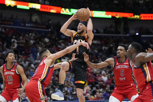 Phoenix Suns' Devin Booker Shines with 52 Points in NBA Victory Against New Orleans Pelicans.