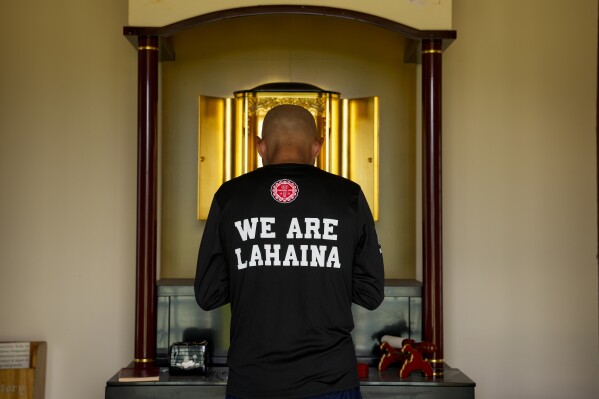 FILE - The Rev. Ai Hironaka, resident minister of the Lahaina Hongwanji Mission, offers a prayer inside the nokotsudo, or columbarium, that survived being destroyed by wildfire, Thursday, Dec. 7, 2023, in Lahaina. (AP Photo/Lindsey Wasson, File)