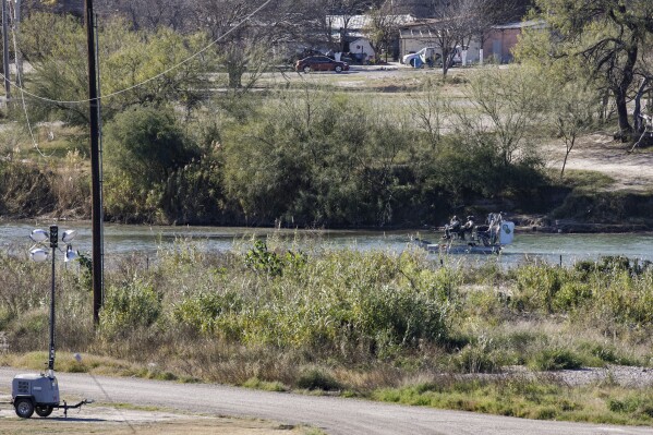 Texas Department of Public Safety officers work inside a fenced off Shelby Park, Thursday, Jan. 11, 2024, in Eagle Pass, Texas. The Justice Department on Friday, Jan. 12, asked the Supreme Court to order Texas to stop blocking Border Patrol agents from a portion of the U.S.-Mexico border where large numbers of migrants have crossed in recent months, setting up another showdown between Republican Gov. Greg Abbott and the Biden administration over immigration enforcement. (Sam Owens /The San Antonio Express-News via AP)