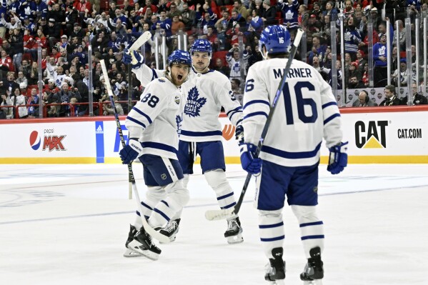 Toronto's William Nylander, left, celebrates scoring during the NHL Global Series Sweden ice hockey match between Toronto Maple Leafs and Detroit Red Wings and at Avicii Arena in Stockholm, Sweden, Friday Nov. 17, 2023. (Henrik Montgomery/TT News Agency via AP)