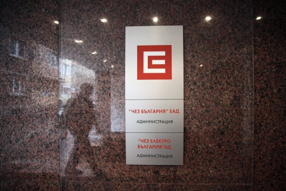 FILE - Reflection of a person is seen at the entrance of CEZ headquarters in Sofia, on Feb. 27, 2013. The Czech power utility CEZ said on Thursday, Aug. 10, 2023 its net profit in the first half of 2023 reached 22.3 billion Czech crowns ($1 billion), down from 33.6 billion in the same period a year ago. (AP Photo/Valentina Petrova, File)