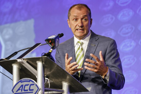 FILE - Atlantic Coast Conference Commissioner Jim Phillips answers a question during an NCAA college football news conference at the ACC media days in Charlotte, N.C., Wednesday, July 20, 2022. Over a span of six weeks this past summer, the Pac-12 was ripped apart and redistributed by its competitors. Oregon and Washington are going to the Big Ten along with Southern California and UCLA. Arizona, Arizona State, Colorado and Utah are going to the Big 12. Stanford and California will join the Atlantic Coast Conference. (AP Photo/Nell Redmond, File)