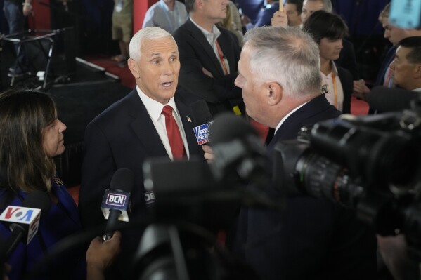 Former Vice President Mike Pence speaks to reporters in the spin room after a Republican presidential primary debate hosted by FOX News Channel Wednesday, Aug. 23, 2023, in Milwaukee. (AP Photo/Morry Gash)