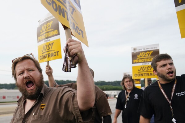 UPS teamsters and workers hold a rally, Friday, July 21, 2023, in Atlanta, as a national strike deadline nears. The Teamsters said Friday that they will resume contract negotiations with UPS, marking an end to a stalemate that began two weeks ago when both sides walked away from talks while blaming each other. (AP Photo/Brynn Anderson)