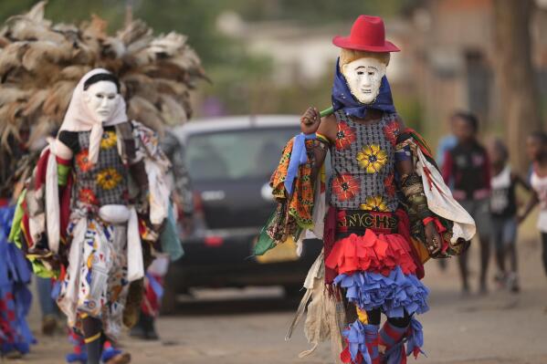 Gule Wamkulu dance secretive society members in gory masks and colorful outfits walk on the streets enroute to their ritual dance performance in Harare, Zimbabwe, Saturday,Oct, 23, 2022.Increasingly opening to the public, one of Africa's most enduring ritualistic society seeks to replace fear with respect in Zimbabwe.(AP Photo/Tsvangirayi Mukwazhi)