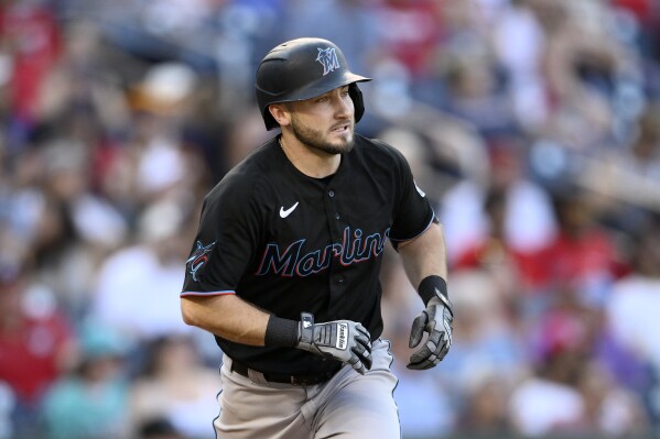 FILE -Miami Marlins' Garrett Hampson watches the ball during a baseball game against the Washington Nationals, Saturday, Sept. 2, 2023, in Washington. Speedy utilityman Garrett Hampson and the Kansas City Royals agreed Wednesday, Nov. 29, 2023 to a $2 million, one-year contract.(AP Photo/Nick Wass, File)