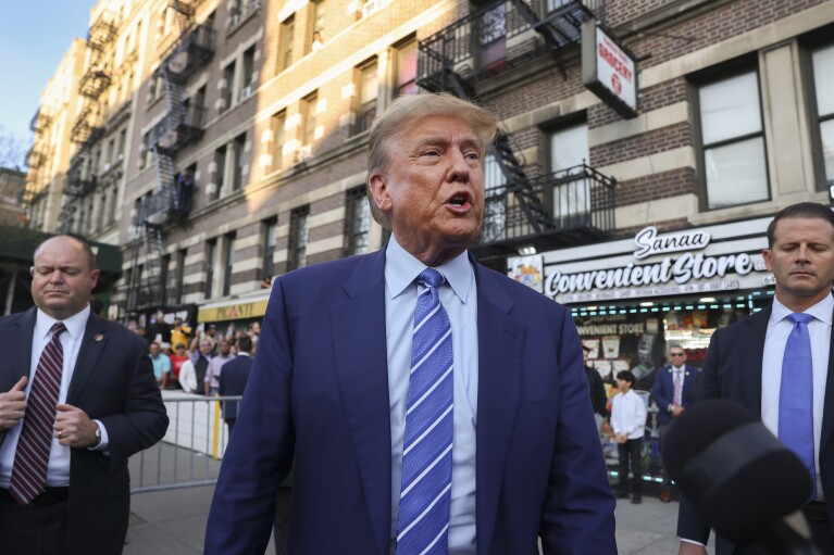 Former president Donald Trump, talks to members of the media while visiting a bodega, Tuesday, April 16, 2024, who's owner was attacked last year in New York. (AP Photo/Yuki Iwamura)