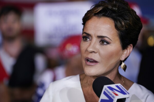 FILE - Former Arizona Republican gubernatorial candidate Kari Lake talks in the Spin Room after former President Donald Trump held a campaign rally, Nov. 8, 2023, in Hialeah, Fla. On Thursday, Nov. 30, a judge rejected Lake’s request to examine signed ballot envelopes of 1.3 million early voters, giving the defeated Arizona Republican candidate for governor another loss in her third trial related to last year’s election. (AP Photo/Lynne Sladky, File)