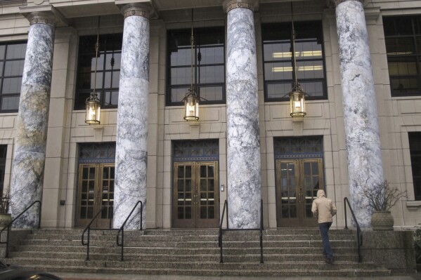FILE - A person walks up the steps of the Alaska Capitol, Jan. 16, 2023, in Juneau, Alaska. The Alaska Legislature opens a new legislative session on Tuesday, Jan. 16, 2024, in Juneau. (AP Photo/Becky Bohrer, File)