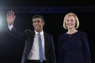 FILE - Liz Truss, right, and Rishi Sunak on stage after a Conservative leadership election hustings at Wembley Arena in London, Aug. 31, 2022. Rishi Sunak, the former British Treasury chief who won the race to be leader of the Conservative Party and is likely to become the country’s next prime minister, is getting cheers from an unlikely place: India, its former colony. Social media and TV channels in India are awash with comments and reactions to the accomplishment by the 42-year-old who has spoken publicly about his Indian roots and Hindu faith.  (AP Photo/Kirsty Wigglesworth, File)