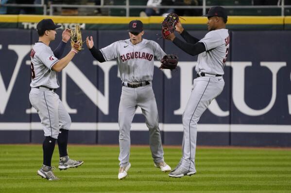 Cleveland Guardians left fielder Steven Kwan, center fielder Myles Straw and right fielder Oscar Gonzalez, from left, celebrate the team's win against the Chicago White Sox in a baseball game Thursday, Sept. 22, 2022, in Chicago. (AP Photo/David Banks)