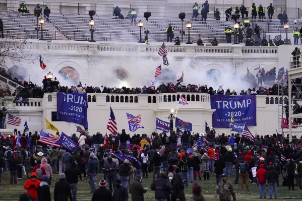 FILE - Violent rioters loyal to President Donald Trump storm the Capitol in Washington on Jan. 6, 2021. Lawsuits playing out in two states this week seeking to keep former President Donald Trump off the ballot rely on a constitutional clause barring those from office who “have engaged in insurrection.” One challenge has become clear during the hearings in Colorado and Minnesota: No one can agree on how to define an insurrection. (AP Photo/John Minchillo, File)