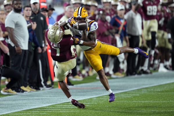 LSU safety Greg Brooks Jr. (3) breaks up a pass intended for Florida State wide receiver Destyn Hill, left, during the first half of an NCAA college football game, Sunday, Sept. 3, 2023, in Orlando, Fla. (AP Photo/John Raoux)