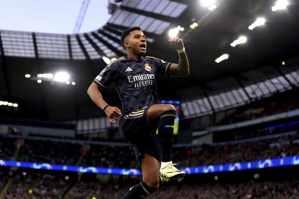 Real Madrid's Rodrygo celebrates scoring the opening goal, during the Champions League quarterfinal, second leg soccer match between Manchester City and Real Madrid, at the Etihad Stadium, in Manchester, England. Wednesday April 17, 2024. (Martin Rickett/PA via AP)
