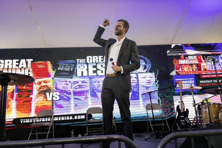 Eric Trump, son of former President Donald Trump, raises a fist as he arrives to speak on stage during the ReAwaken America Tour at Cornerstone Church in Batavia, N.Y., Friday, Aug. 12, 2022. (AP Photo/Carolyn Kaster)