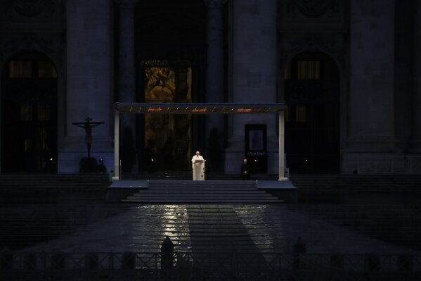 FILE - In this file photo taken on March 27, 2020, Pope Francis delivers the Urbi and Orbi prayer in an empty St. Peter's Square, at the Vatican. If ever there was a defining moment of Pope Francis during the coronavirus pandemic, it came on March 27, the day Italy recorded its single biggest daily jump in fatalities. From the rain-slicked promenade of St. Peter’s Basilica, Francis said the virus had shown that we’re all in this together, that we need each other and need to reassess our priorities. (AP Photo/Alessandra Tarantino, File)