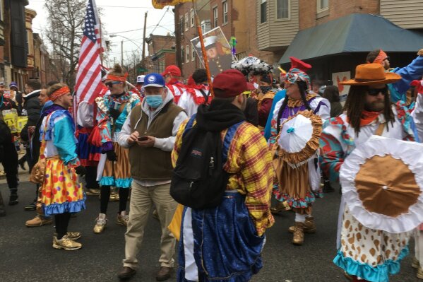 Costumed participants take to the streets of their south Philadelphia stomping grounds for a New Year’s celebration of Mummers tradition despite official cancellation of the annual event and a ban on large gatherings due to the coronavirus pandemic, Friday, Jan. 1, 2021 in Philadelphia. (AP Photo/Ron Todt)