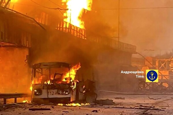 In this photo provided by Petro Andryuschenko, the adviser of the head of Mariupol city's administration, burning trolleybus is seen on the damp of hydroelectric power station after Russian attacks in Dnipro, Ukraine, Friday, March 22, 2024. Over 60 drones and almost 90 missiles of various types were fired that night, Ukrainian officials said. (Telegram Channel of Petro Andryuschenko, the adviser of the head of Mariupol city's administration via AP)