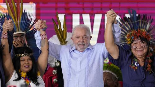 Brazilian President Luiz Inacio Lula da Silva, center, stands between Indigenous Peoples Minister Sonia Guajajara, left, and National Indigenous Foundation President Joenia Wapichana at the closing of the annual Terra Livre, or Free Land Indigenous Encampment in Brasilia, Brazil, Friday, April 28, 2023. (AP Photo/Eraldo Peres)