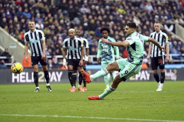 Fulham's Aleksandar Mitrovic scores his side's first goal of the game from a penalty kick before being ruled out for touching the ball twice, during the English Premier League soccer match between Newcastle United and Fulham, at St. James' Park, Newcastle, England, Sunday Jan. 15, 2023. (Owen Humphreys/PA via AP)