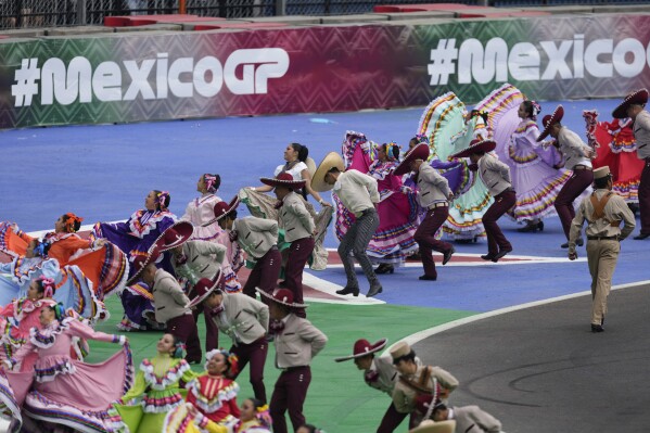 Dancers perform during a drivers parade before the Formula One Mexico Grand Prix auto race at the Hermanos Rodriguez racetrack in Mexico City, Oct. 27, 2024. (AP Photo/Eduardo Verdugo, File)