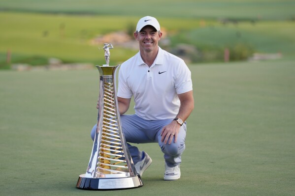 Rory McIlroy of Northern Ireland poses with his Race to Dubai trophy after the final round of the DP World Tour Championship golf tournament, in Dubai, United Arab Emirates, Sunday, Nov. 19, 2023. (AP Photo/Kamran Jebreili)