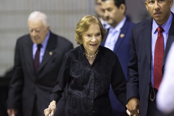 FILE - Former first lady Rosalynn Carter arrives with her husband, former President Jimmy Carter, left, for an annual Carter Town Hall held at Emory University, Sept. 18, 2019, in Atlanta. Rosalynn Carter, the closest adviser to Jimmy Carter during his one term as U.S. president and their four decades thereafter as global humanitarians, died Sunday, Nov. 19, 2023. She was 96. (AP Photo/John Amis, File)