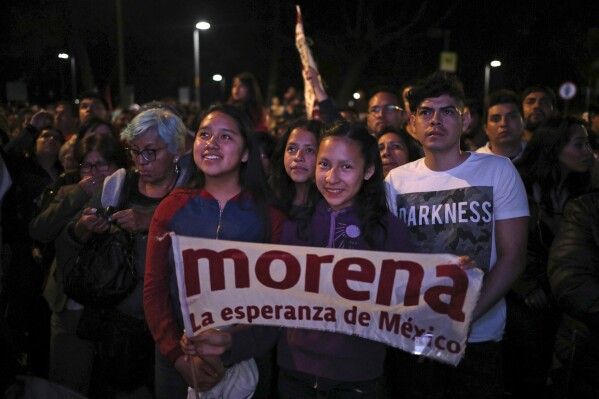 FILE - Supporters of presidential candidate Andres Manuel Lopez Obrador, of the Morena party, wait for his arrival at Mexico City's Zocalo plaza, July 1, 2018. Mexico’s ruling party will announce its candidates for the 2024 gubernatorial elections on Nov. 10, 2023. (AP Photo/Emilio Espejel, File)