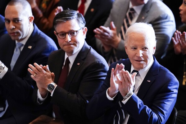 President Joe Biden, with from left, House Minority Leader Hakeem Jeffries, D-N.Y., and House Speaker Mike Johnson of La., listen during the National Prayer Breakfast, Thursday, Feb. 1, 2024, at the Capitol in Washington. (AP Photo/J. Scott Applewhite)