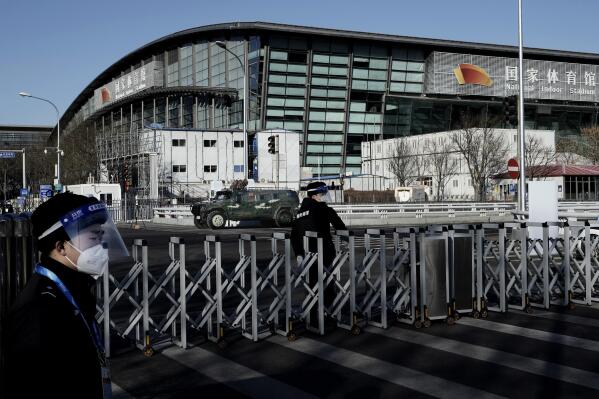 Chinese security stand guard outside the National Indoor Stadium ahead of the 2022 Winter Olympics, Wednesday, Feb. 2, 2022, in Beijing. (AP Photo/Nariman El-Mofty)