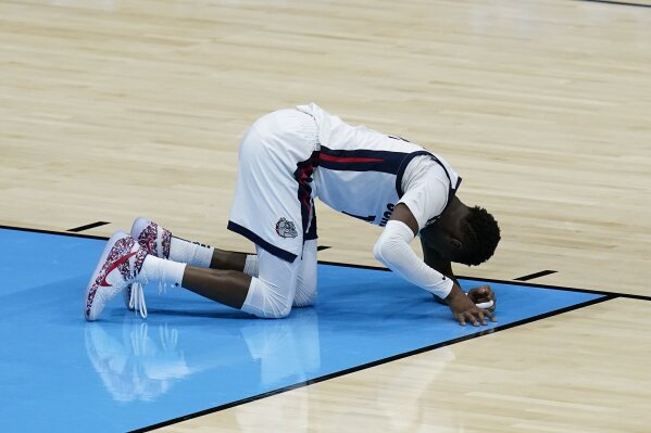 Gonzaga guard Joel Ayayi rests on the court after getting injured during the second half of the championship game against Baylor in the men's Final Four NCAA college basketball tournament, Monday, April 5, 2021, at Lucas Oil Stadium in Indianapolis. (AP Photo/Darron Cummings)
