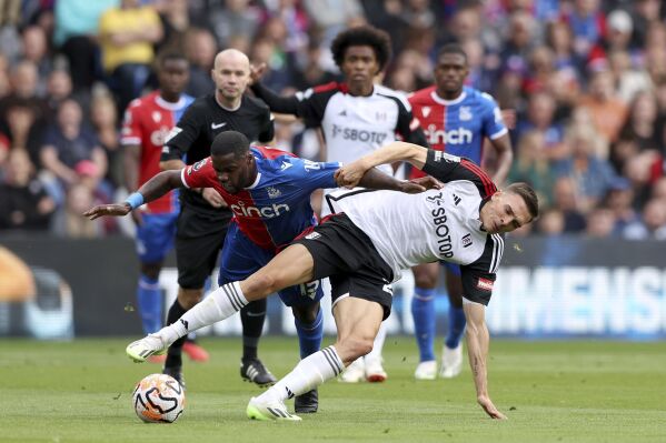 Crystal Palace's Jeffrey Schlupp, left and Fulham's Joao Palhinha vie for the ball, during the English Premier League soccer match between Crystal Palace and Fulham at Selhurst Park, London, Saturday, Sept. 23, 2023. (Kieran Cleeves/PA via AP)
